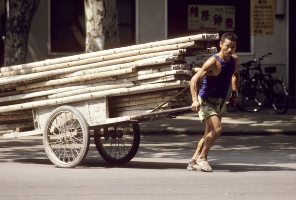 Worker hauls iron bars